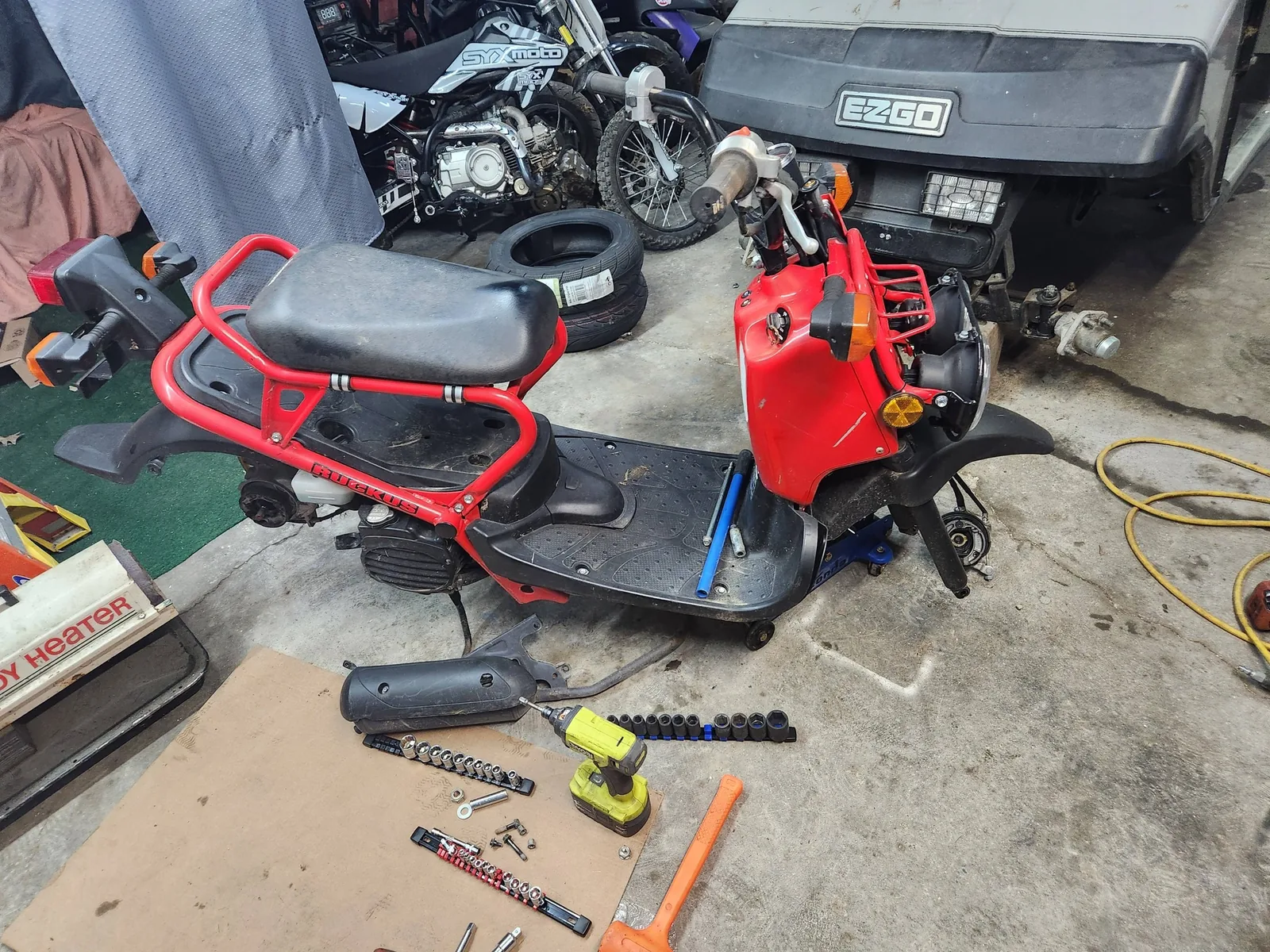 Red scooter undergoing repair